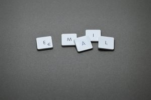 A top-down view of a computer keyboard with keys rearranged to spell out the word 'EMAIL' in capital letters.